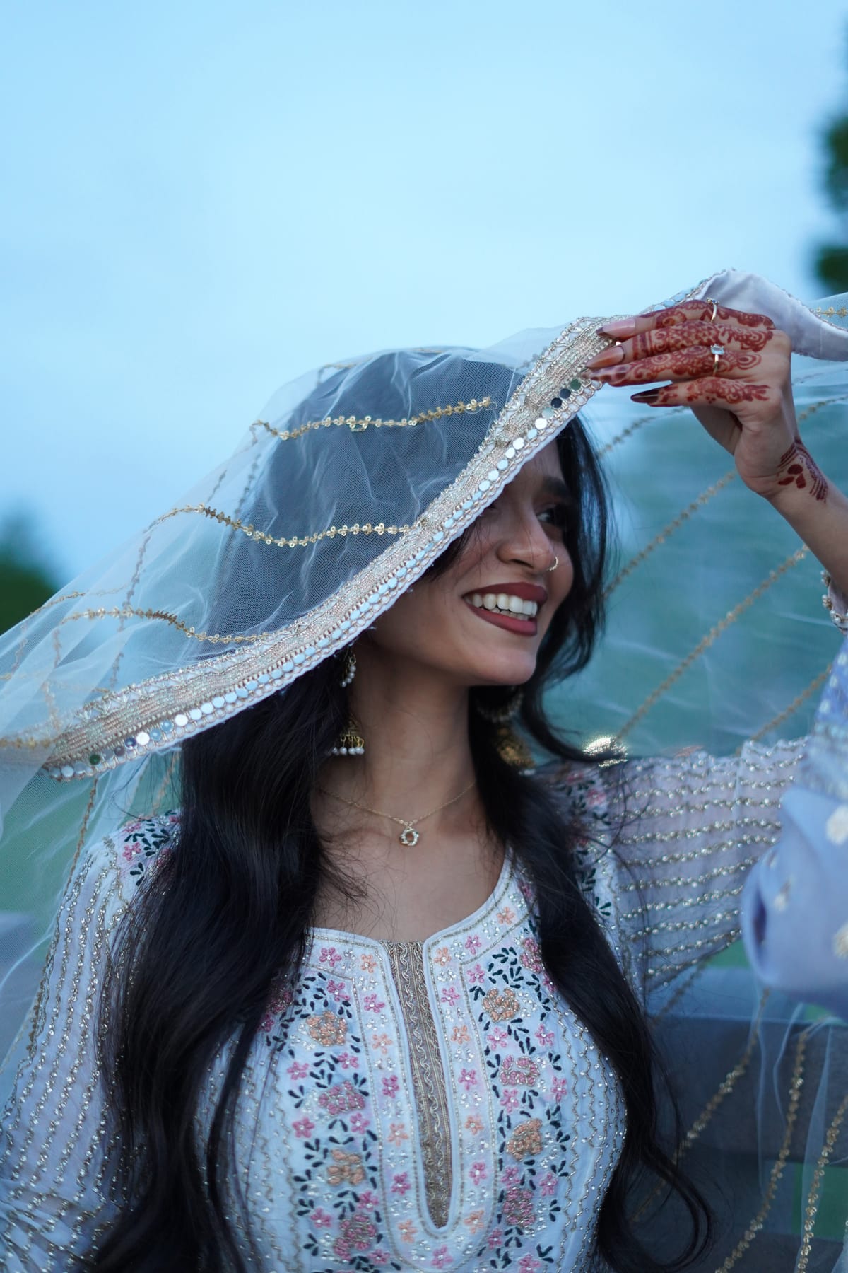 A smiling bride outdoors